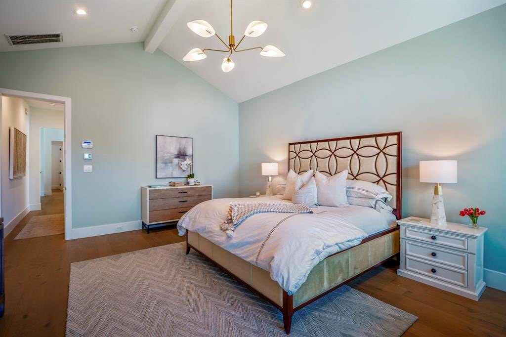 Another perspective of this primary bedroom, showcasing its seamless connection to the flow of the second floor and tucked away in the back corner of the home, overlooking your tranquil backyard space.