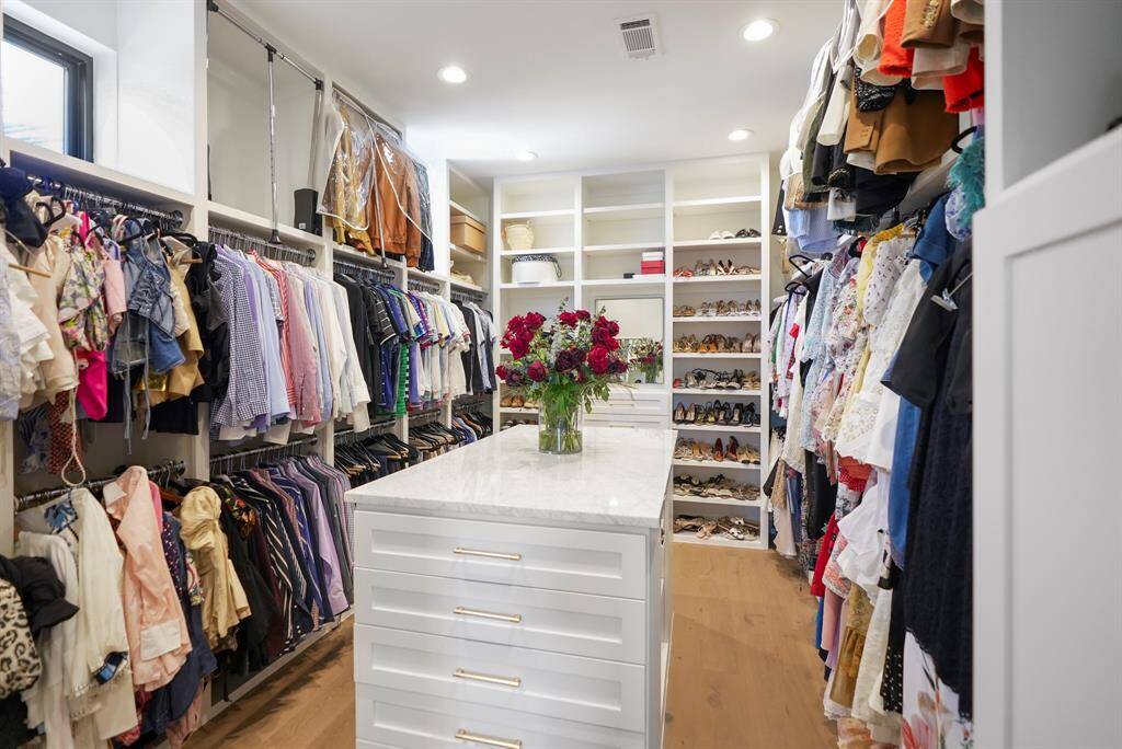 A fashion lover's dream, featuring generous storage, custom built-ins, and a central island that adds both functionality and elegance to the space.