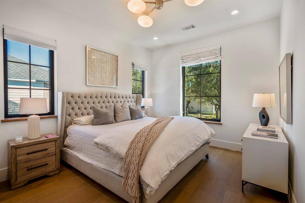 This secondary en-suite bedroom overlooking the front of the home is spacious enough for a king-sized bed. Three large windows allow for beautiful morning sun.