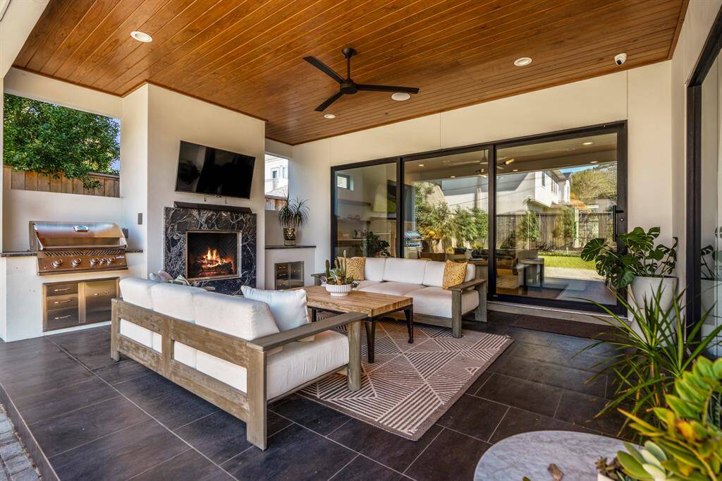 A grand set of siding glass doors seamlessly merge indoor comfort with the beauty of the outdoors, creating a fluid transition between home and nature.