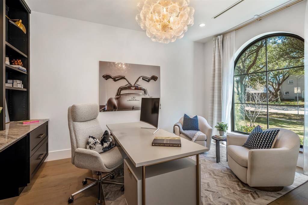 A large arched window allows for ample natural light inside your home office.