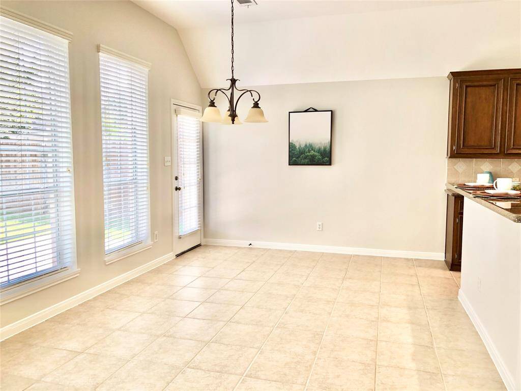 The spacious breakfast area is connected to the breakfast bar and kitchen.