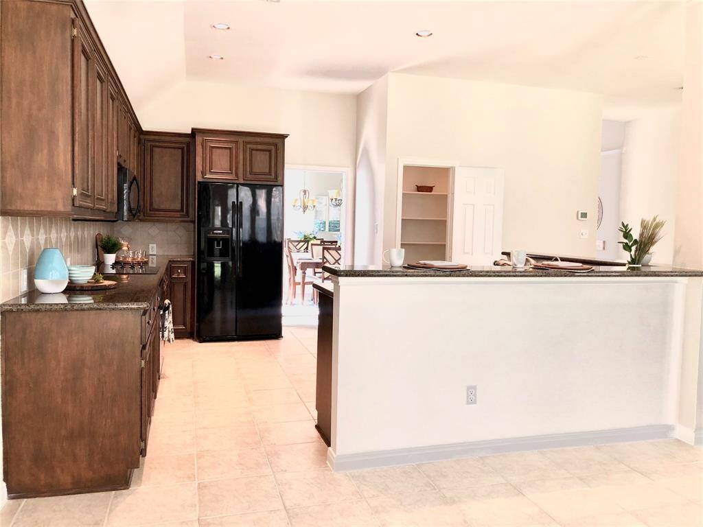 The spacious kitchen is in the middle of dining room and breakfast area.