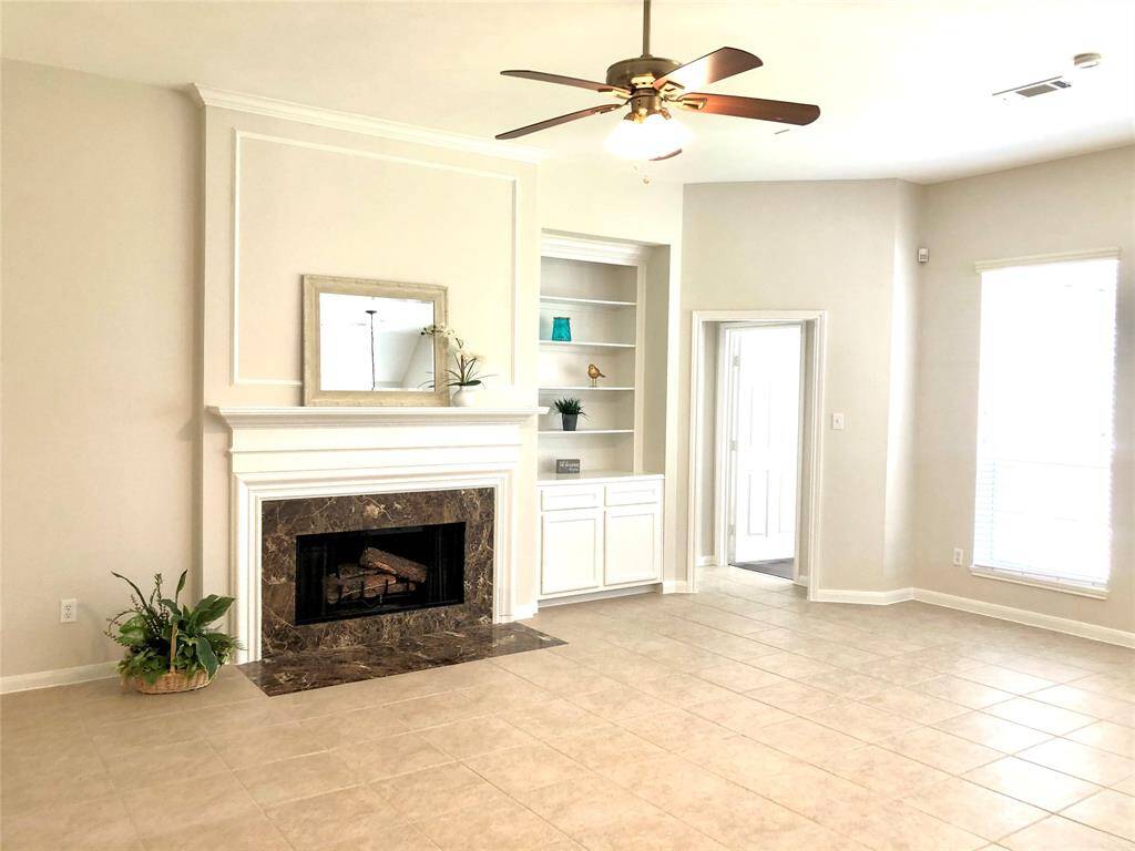 An inviting family room with a cozy fireplace and prewired for speakers. Convenient built ins.