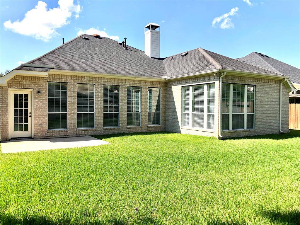 This home has beautiful large windows and gutters.