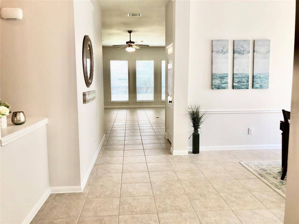 A nice hallway welcomes you home with high ceilings.
