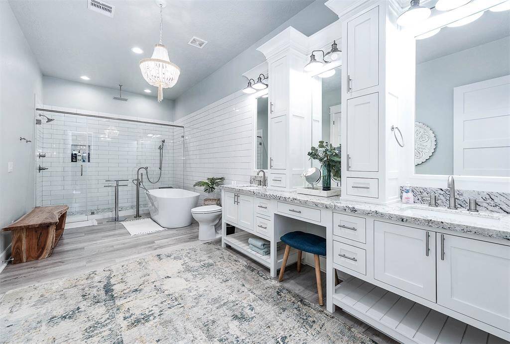 Primary bathroom emanates elegance and grace.