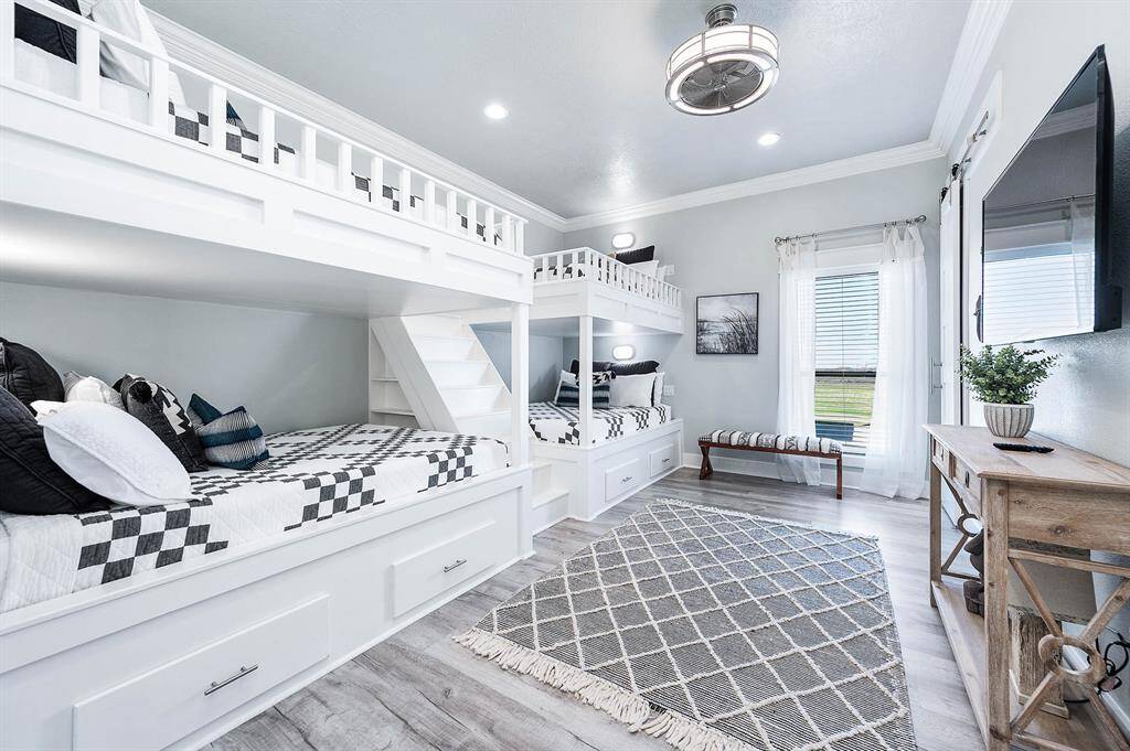 Custom built-in bunk beds complete with nautical themed lighting in each space.