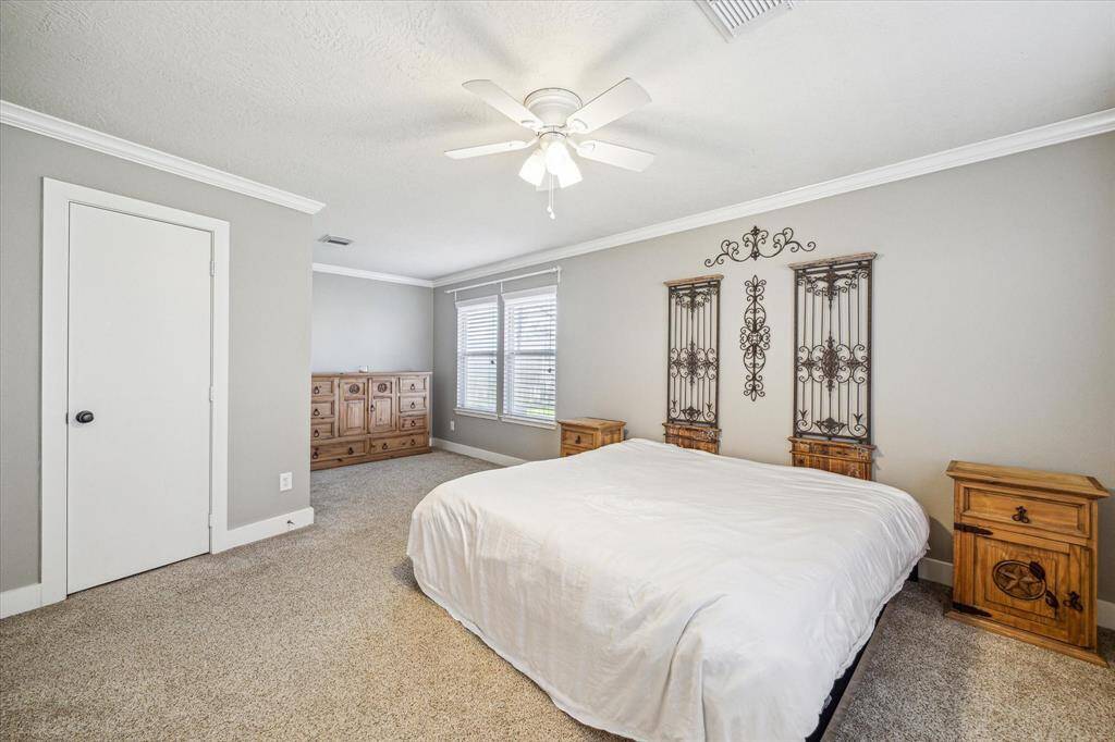 The primary bedroom offers a charming sitting area, providing an intimate space to unwind and enjoy quiet moments. Whether for reading or relaxing, this area adds an extra layer of comfort and sophistication to your bedroom.