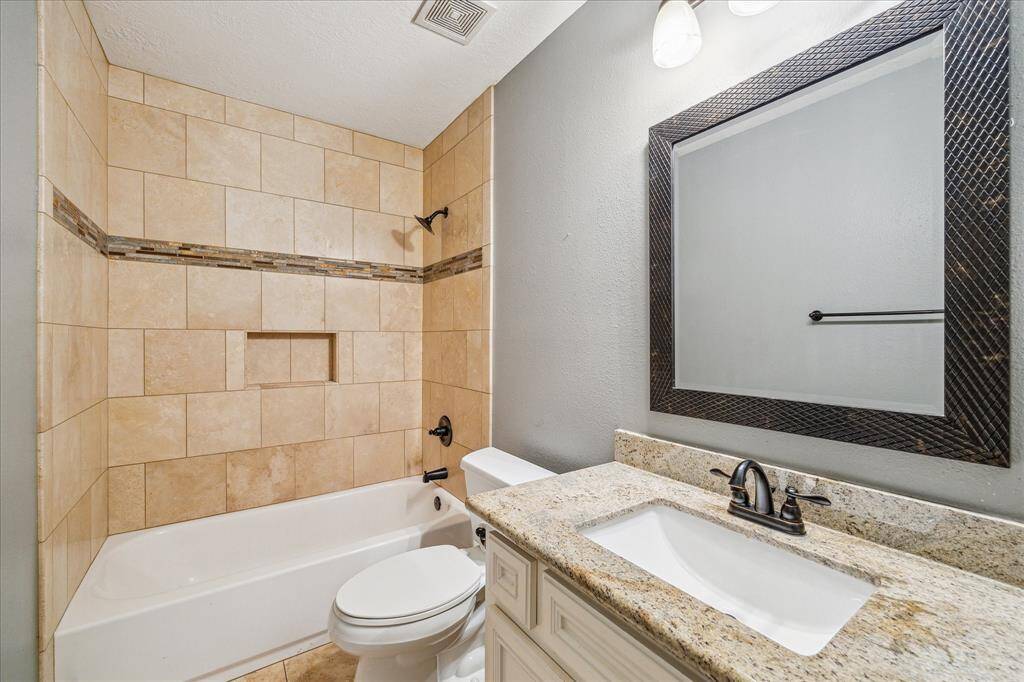 The secondary bathroom offers a classic tub, combining style and function. Perfect for families or guests, this bathroom provides a soothing space for a quick bath or relaxing soak.