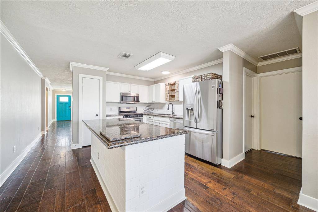 The kitchen boasts a large, central island that adds both function and style to the heart of the home. Whether you're cooking, socializing, or enjoying a casual meal, this space is designed for maximum convenience and enjoyment.