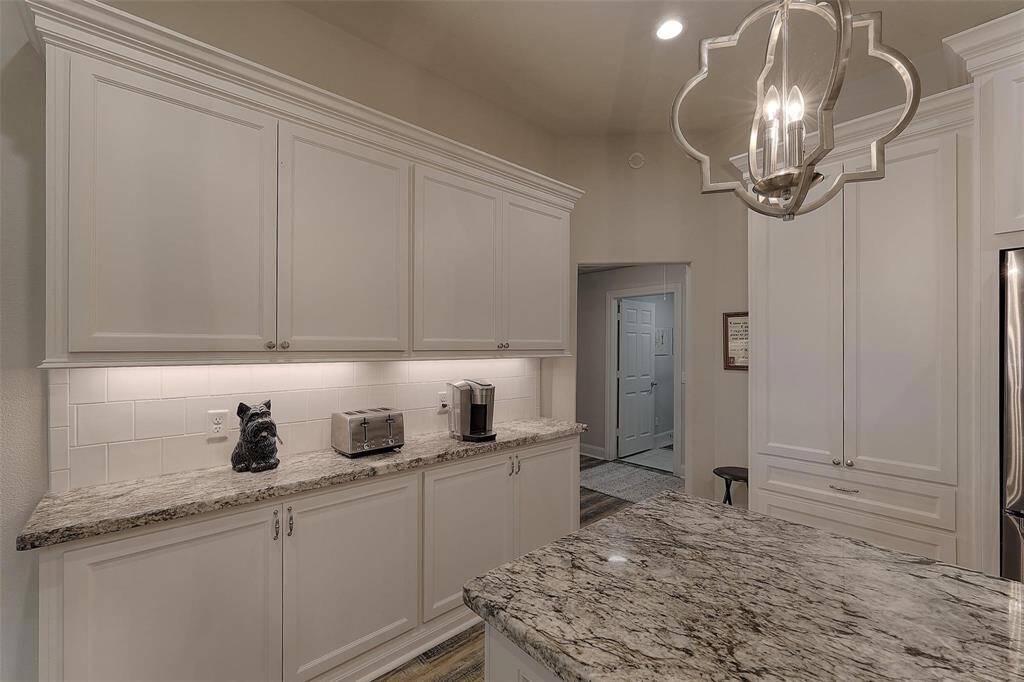 Plenty of counter and cabinet space! This particular counter can be used as a coffee bar or serving buffet. Notice the extra storage space to the right in this photo.