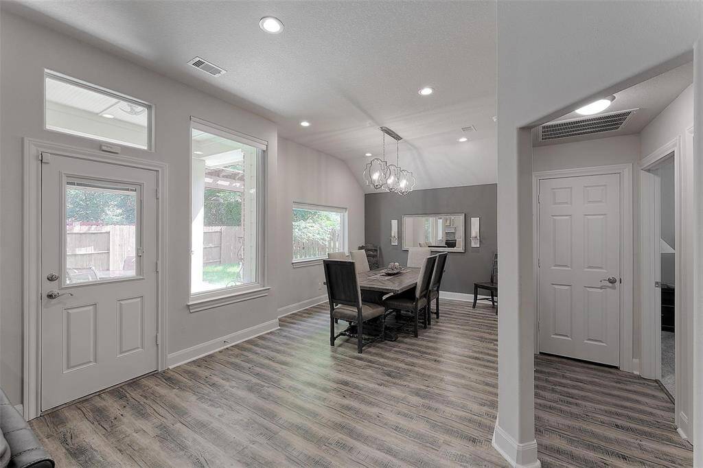 Dining area off of the living room and a glass door leading to the back porch.