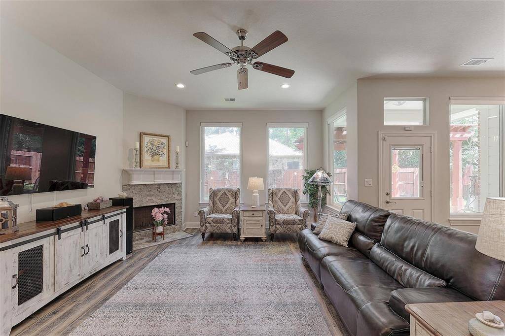 Living room is surrounded by windows for plenty of natural light.
