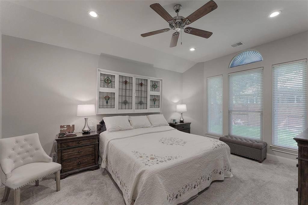 Primary bedroom is large enough for a small seating area and is bright with large windows overlooking the back yard.