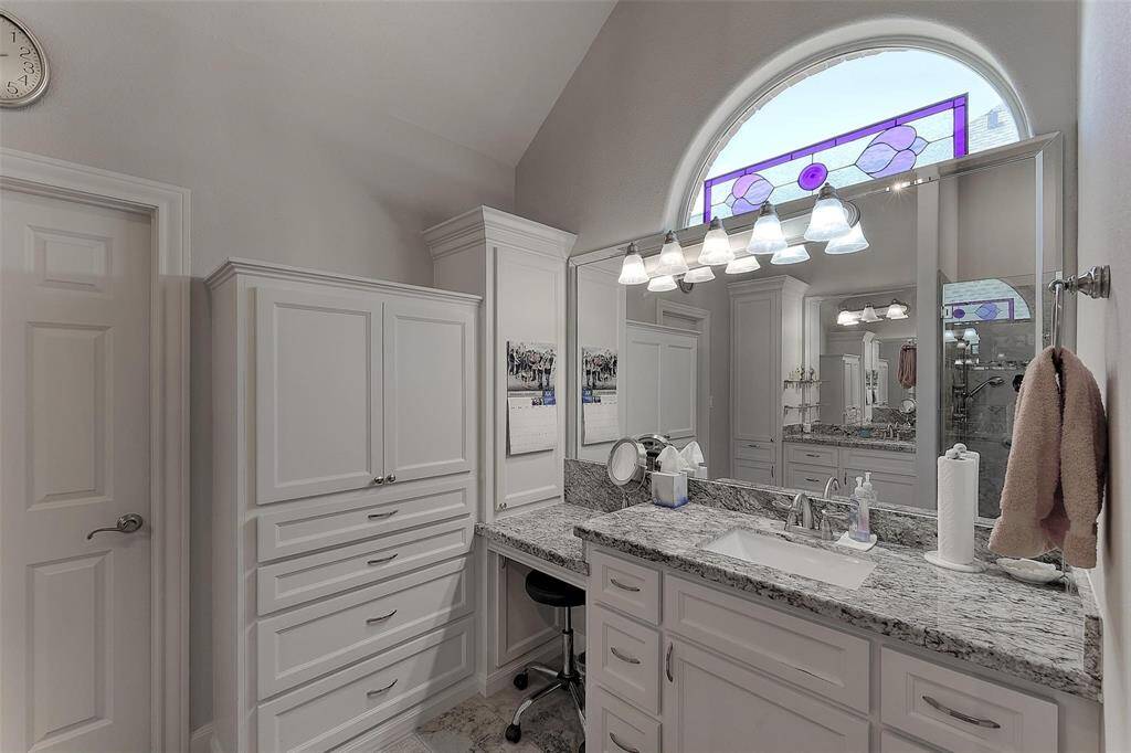 Vanity area with plenty of storage and natural light.