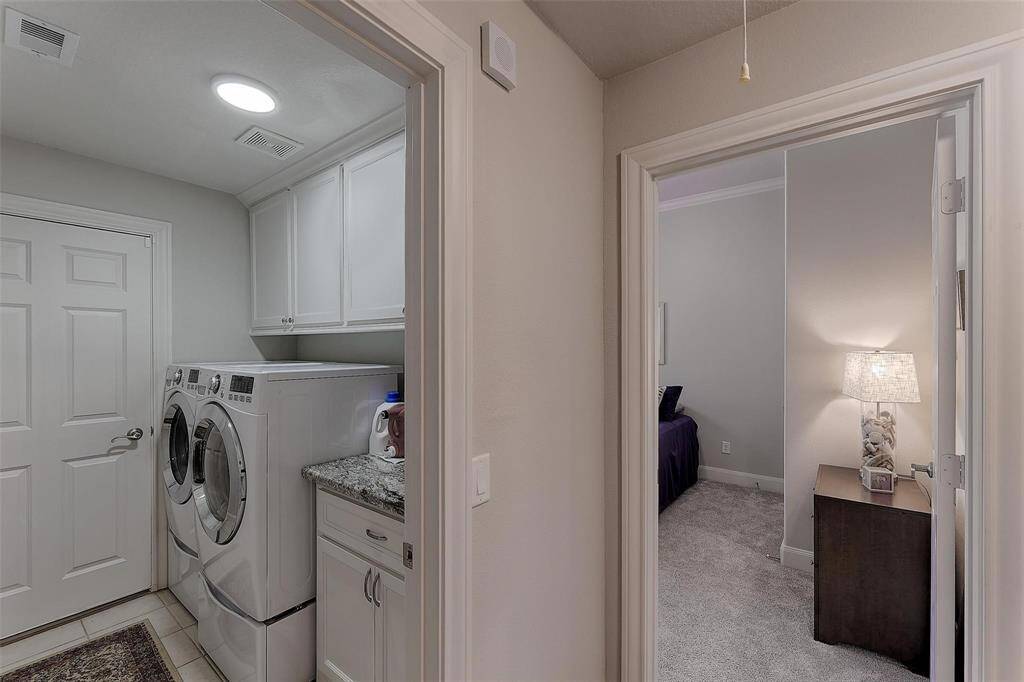 Laundry room and bedroom are off of the kitchen. Extra counter space and plenty of storage in the laundry which also accesses the garage.