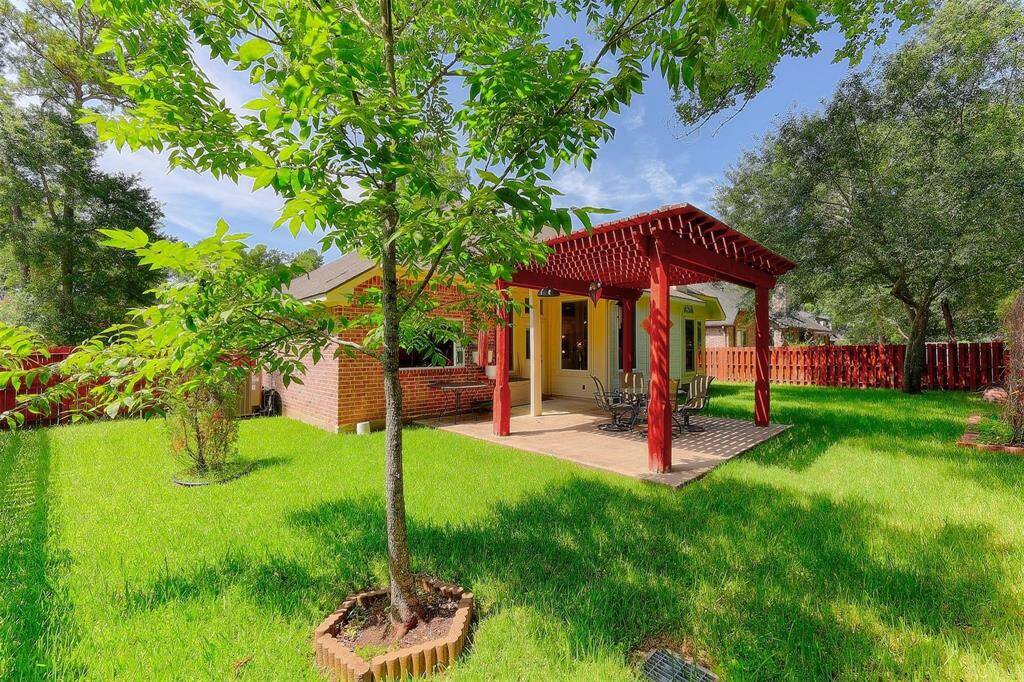 Shaded back yard provides space for entertaining. Park your grill under the pergola and dine outdoors!