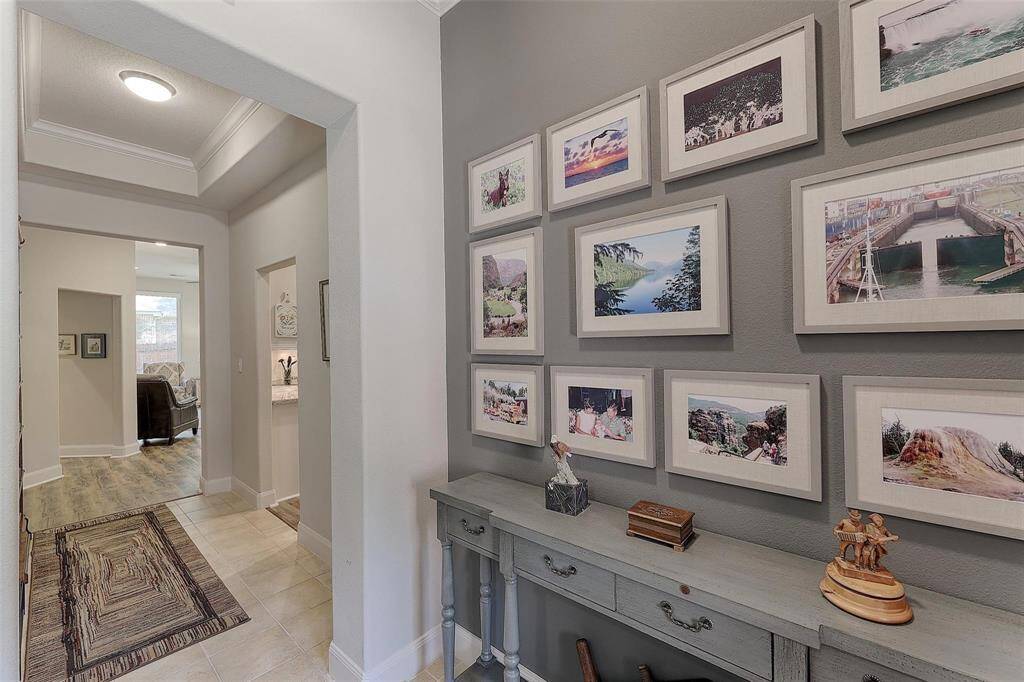 Entry features crown molding, tray ceiling and neutral paint to coordinate with any decor.