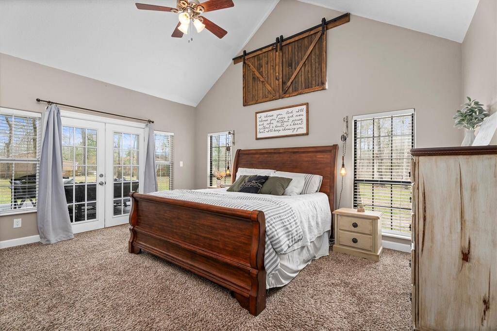 Primary bedroom has french doors leading to back porch.
