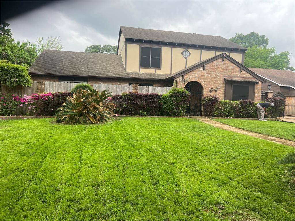 Charming brick home with lush landscaping and a welcoming gated entry. A perfect blend of comfort and privacy awaits you. Ideal for serene family living.