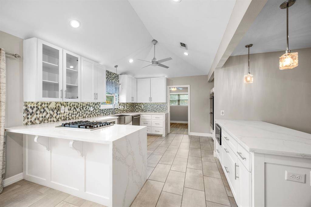 Kitchen with two breakfast bars to sit at.