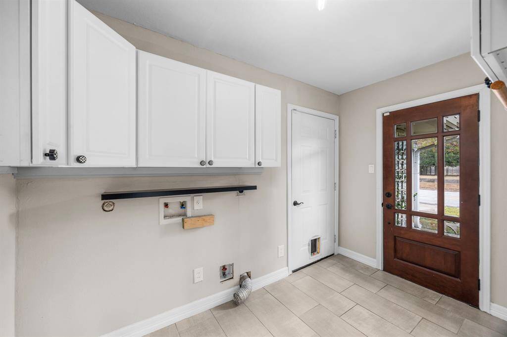 Full size freezer/ refrigerator included.  Utility room off of the kitchen.  Door on the left leads to the garage.