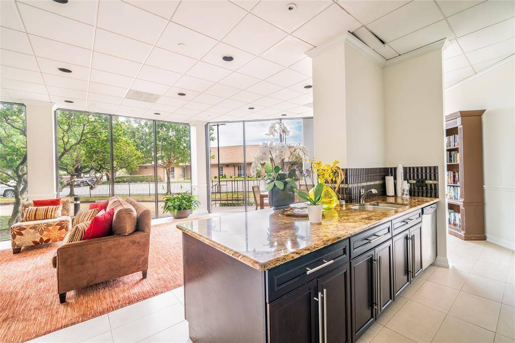 Elegant club house party room featuring abundant natural light, stylish seating, and a convenient wet bar. Perfect for entertaining.