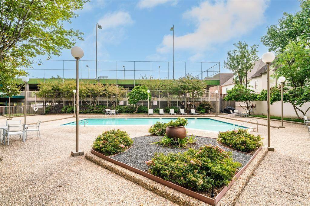 Enjoy a beautifully landscaped oasis featuring a sparkling pool and private tennis court, perfect for relaxation and recreation.