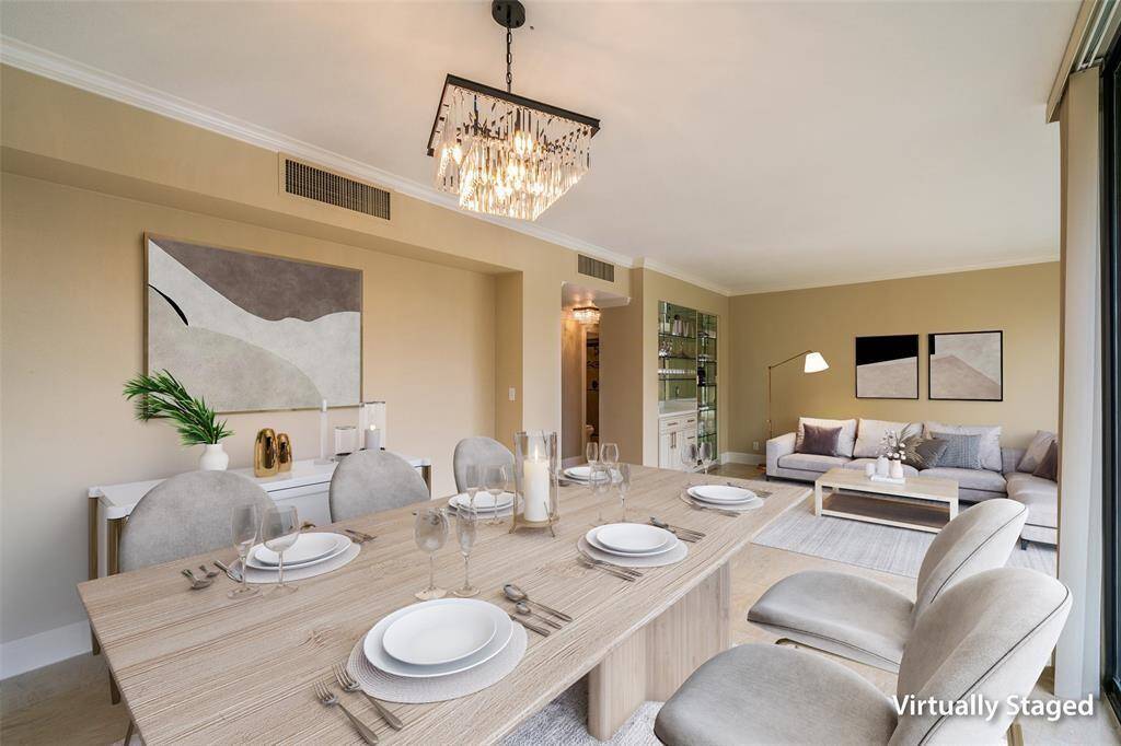 This virtually staged photo showcases a modern dining and living area with a neutral color palette. It features a contemporary chandelier. Large windows allow for ample natural light, enhancing the open and inviting atmosphere.