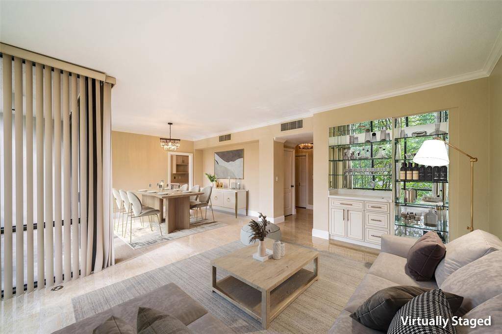 The space features large windows with vertical blinds, a modern light fixture above the dining table, and a built-in mirrored shelving unit, creating a bright and inviting atmosphere.