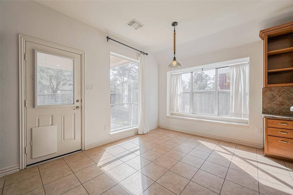 Another view of this spacious breakfast room and large windows
