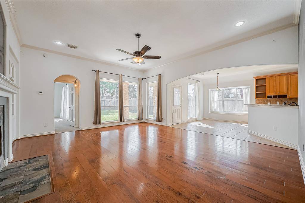 Another view of this large family room with open concept looking into breakfast room and kitchen.