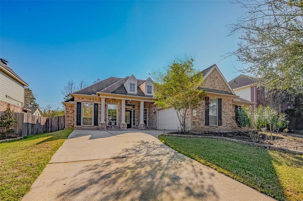 This extra long driveway leads up to a covered entryway, creating an inviting curb appeal.