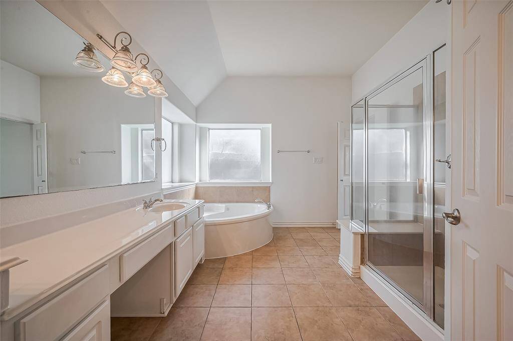 Another view of this large primary bathroom from the large walk-in closet.