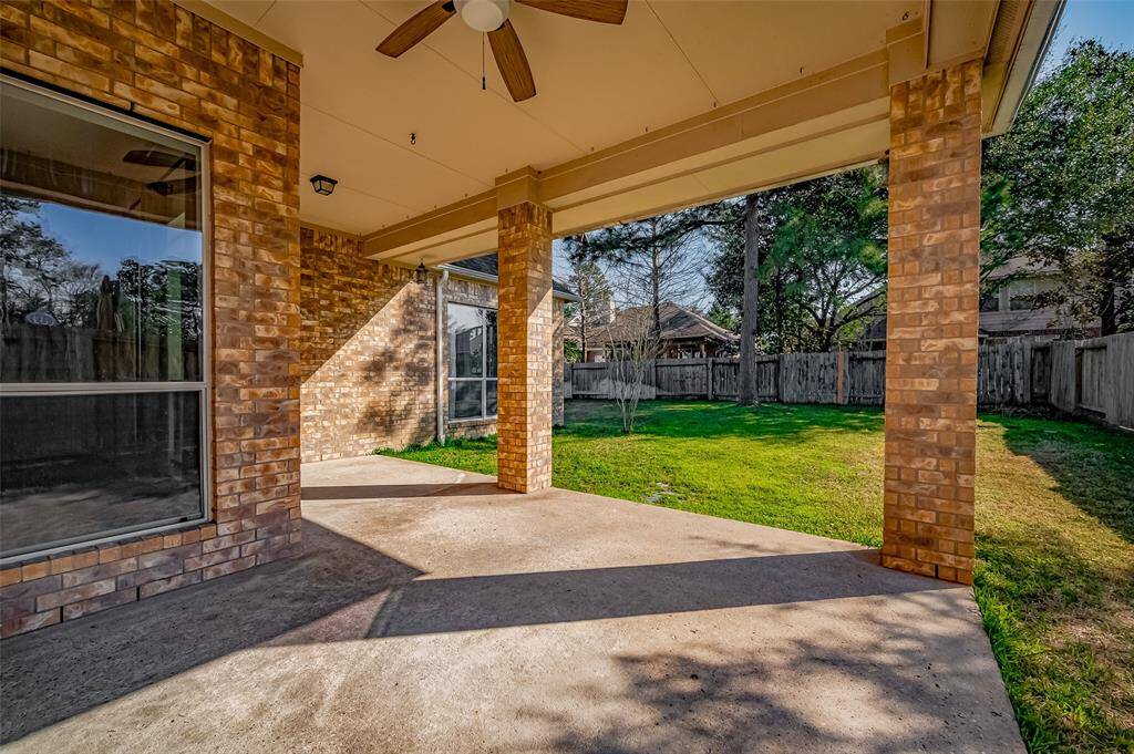 Another view of this spacious covered patio that extends from outside the breakfast room, around to the family room.