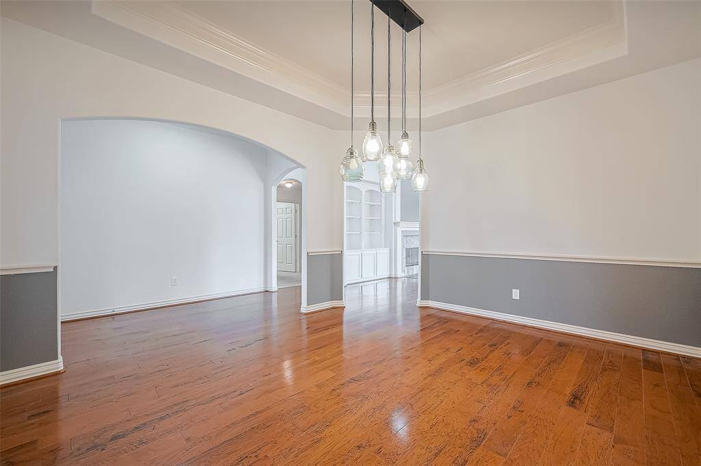 This dining room boasting with crown molding and shutters, is very spacious, elegant, and perfect for hosting special gatherings