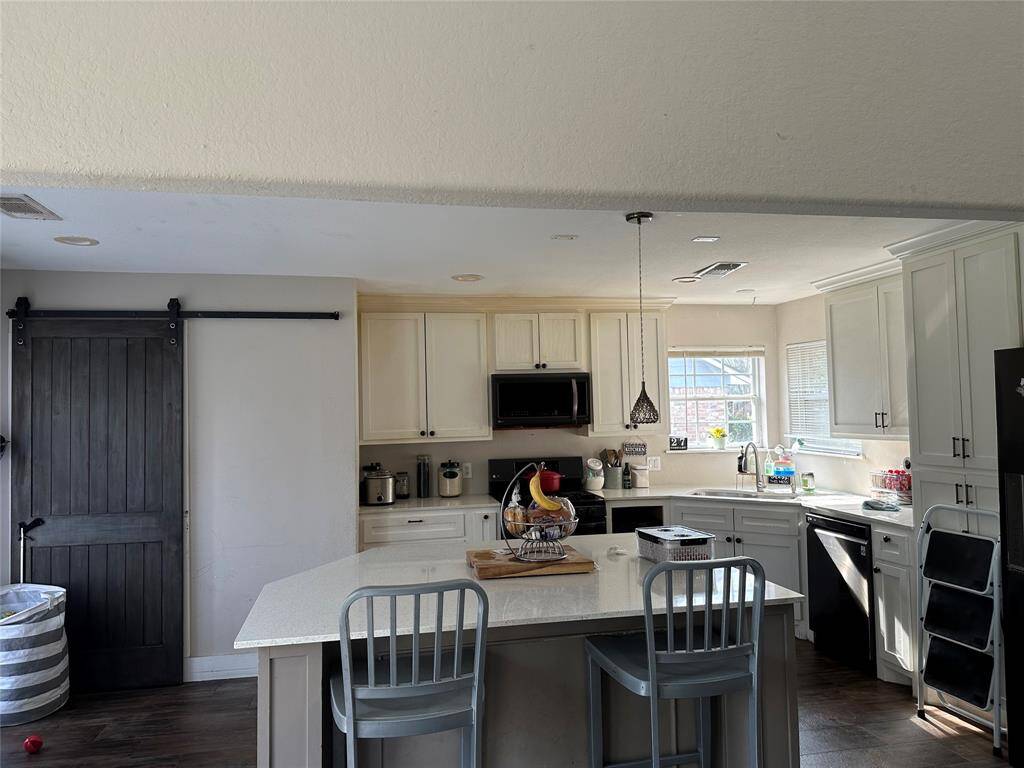 Kitchen with a nice window lots of light.