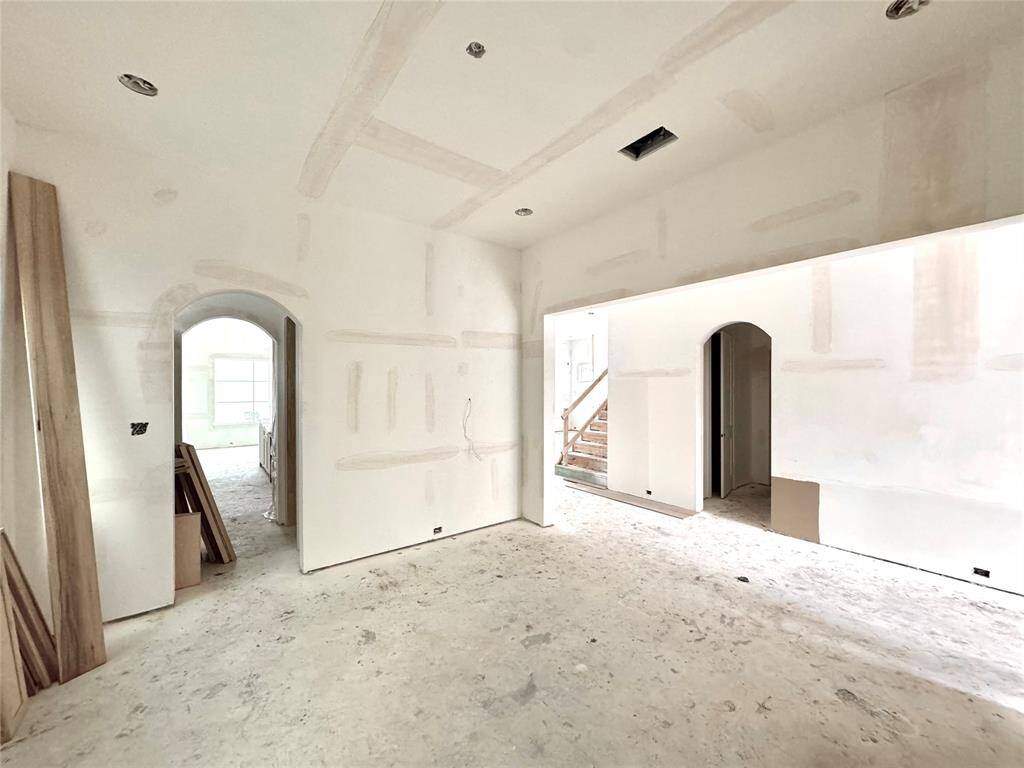 Beautiful arched doorways, one leading to the butler's pantry and the other leading to the powder bath and mudroom.