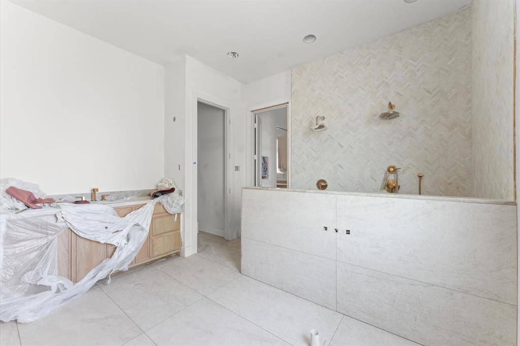 Large dual shower and 1 of 2 custom vanities.