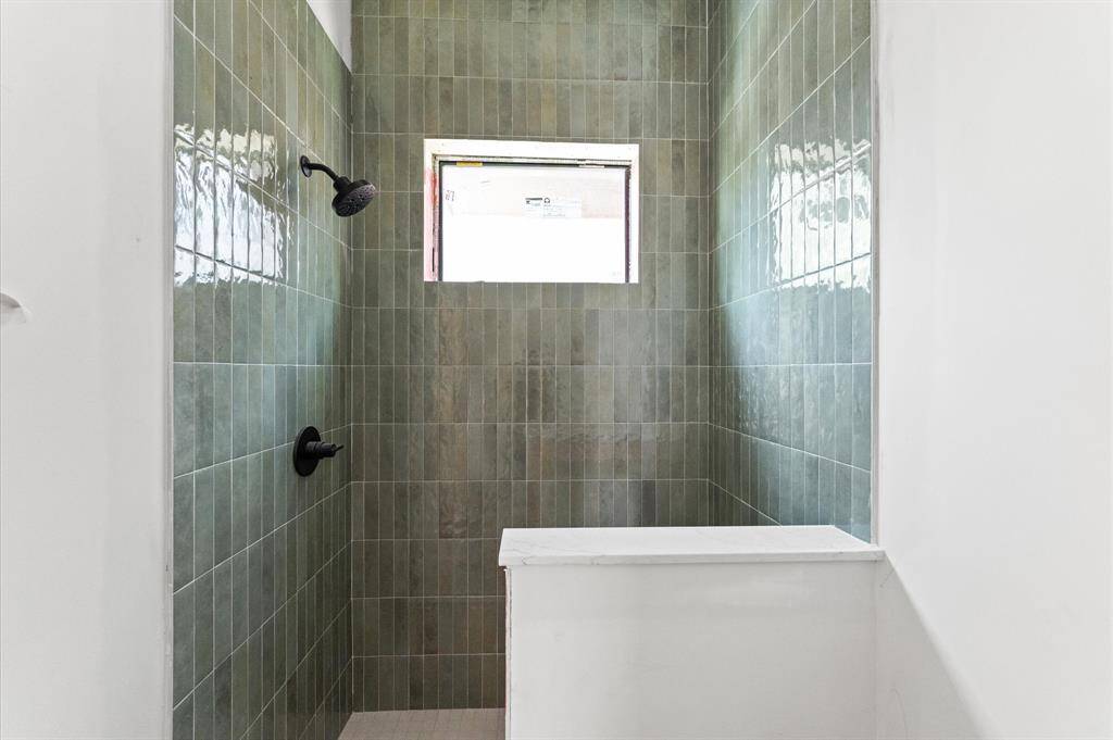 Bath 5 has large shower, custom shaker cabinets and Citrine quartz countertops.