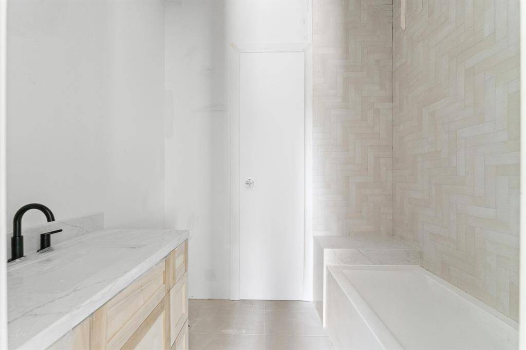 Bath 2 has custom shaker cabinets, quartz countertops and an alcove tub/shower combo.