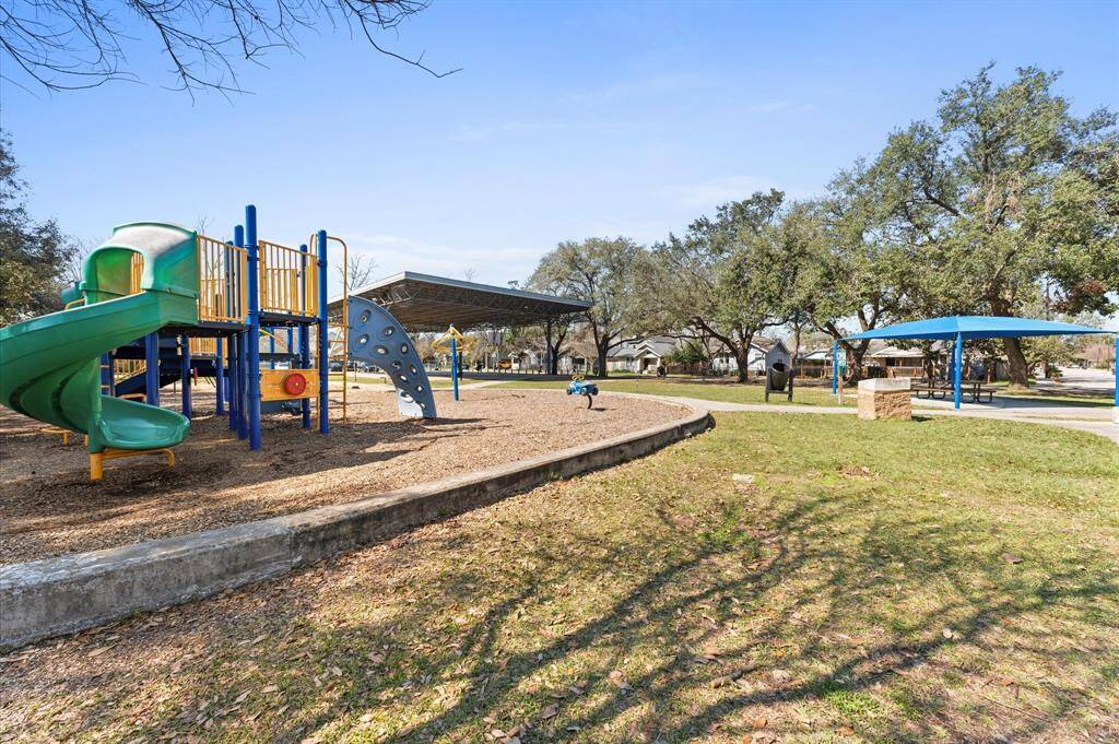 Well maintained playground at the park with plenty of green space for kids to run and play.