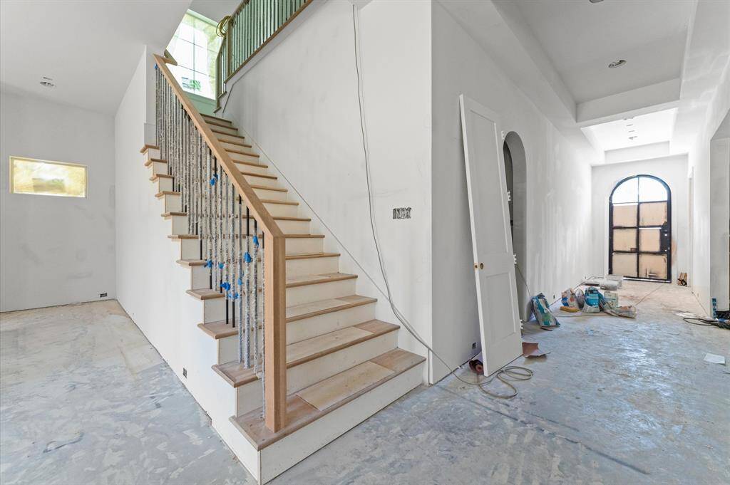 Contemporary staircase with iron balusters adds a stylish touch!
