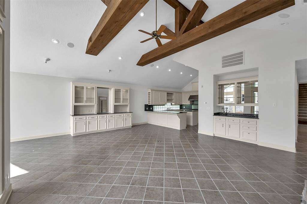 Living Room with view to build-ins, Kitchen and Wet Bar.
