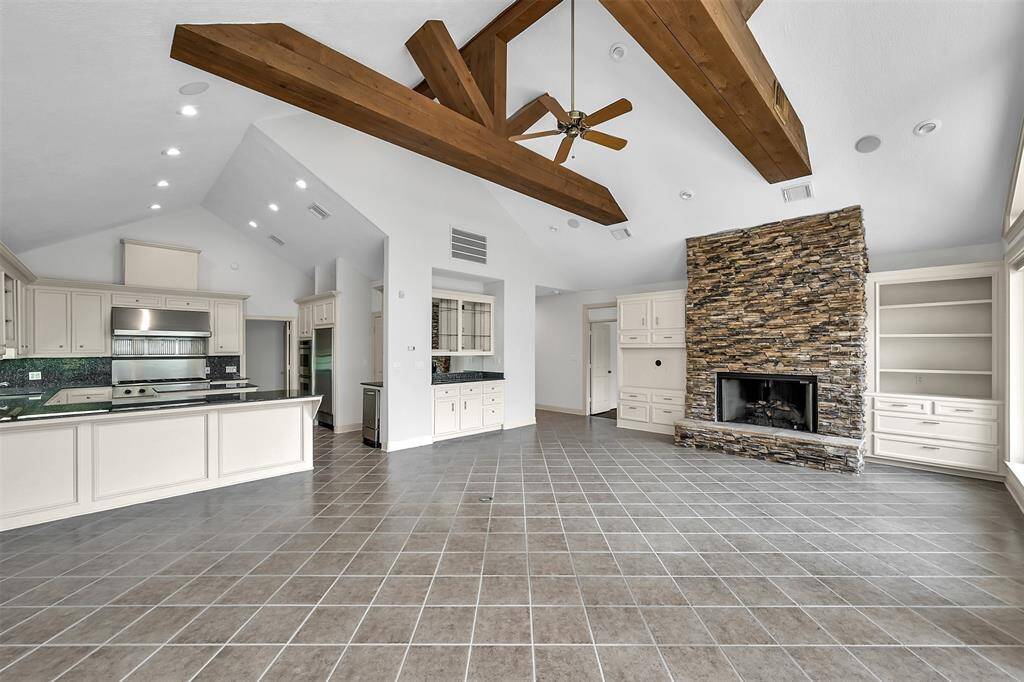 Open concept . . . living room, dining room, and kitchen. With high, beamed ceilings.