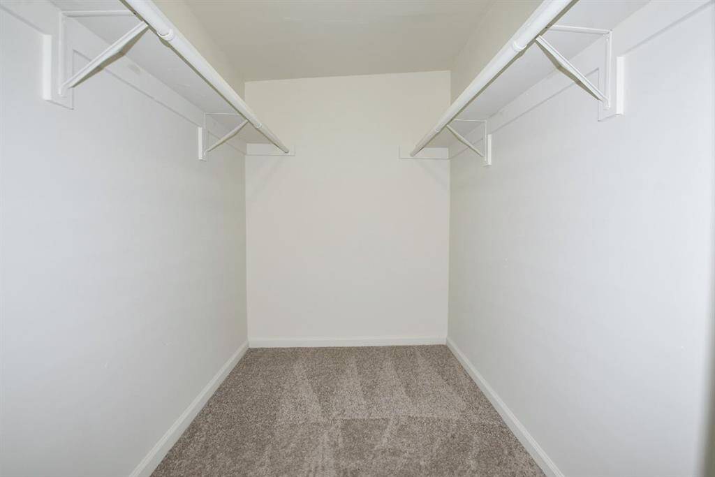Primary bedroom walk in closet