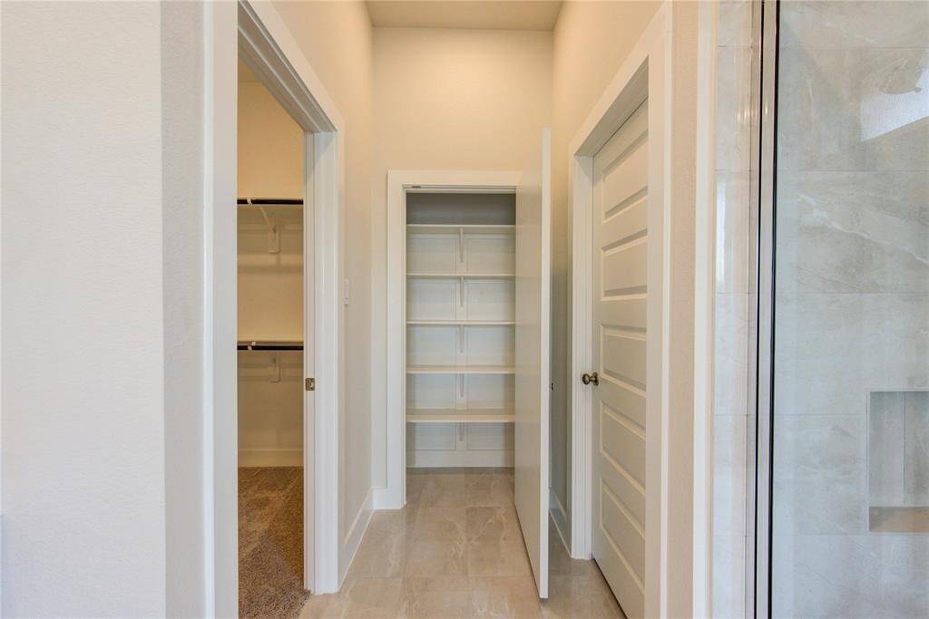 Linen closet in primary with enormous walk-in closet to the left.