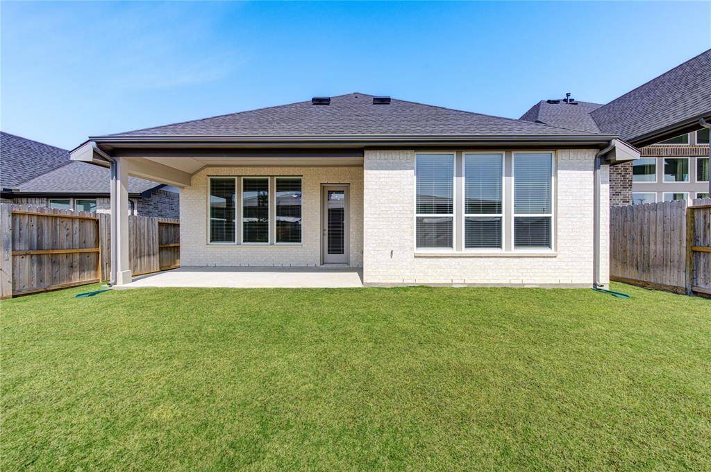 Spacious backyard and covered back porch.