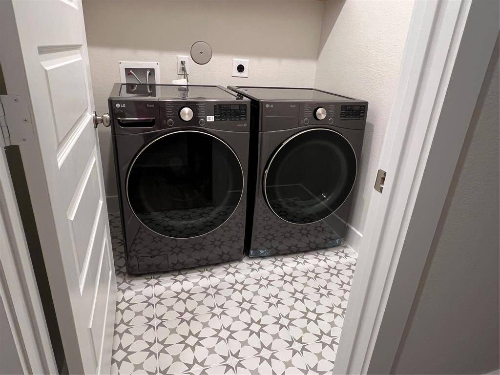 Brand new full side by side washer and dryer and cabinets above.